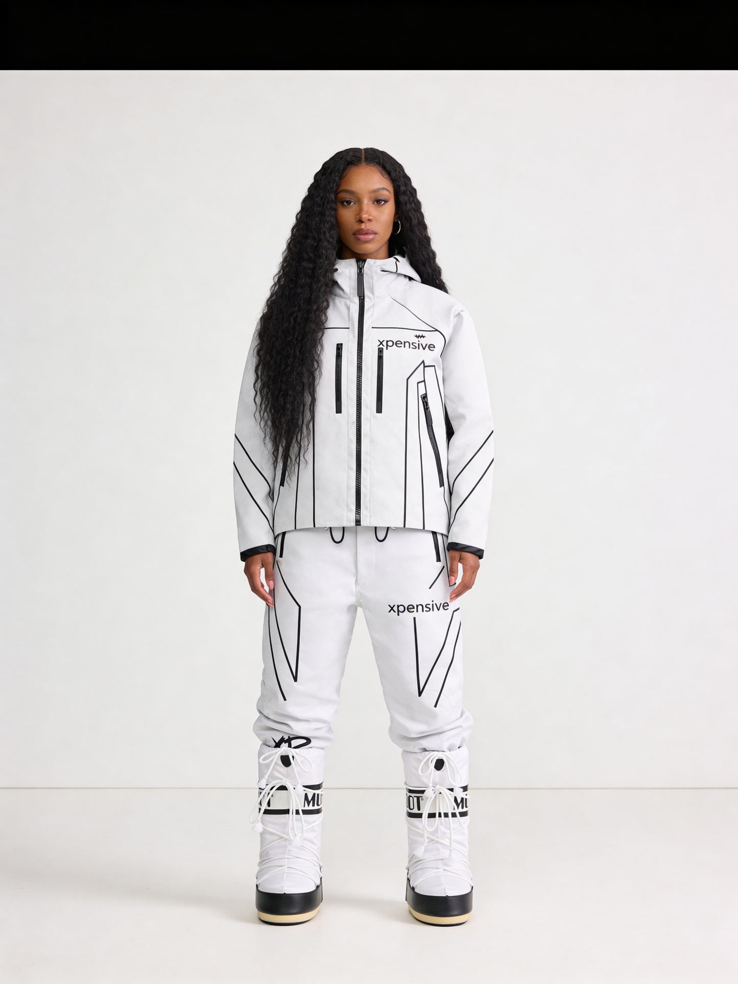 Person wearing a white and black snowsuit with 'Xpedition' branding on a white background
