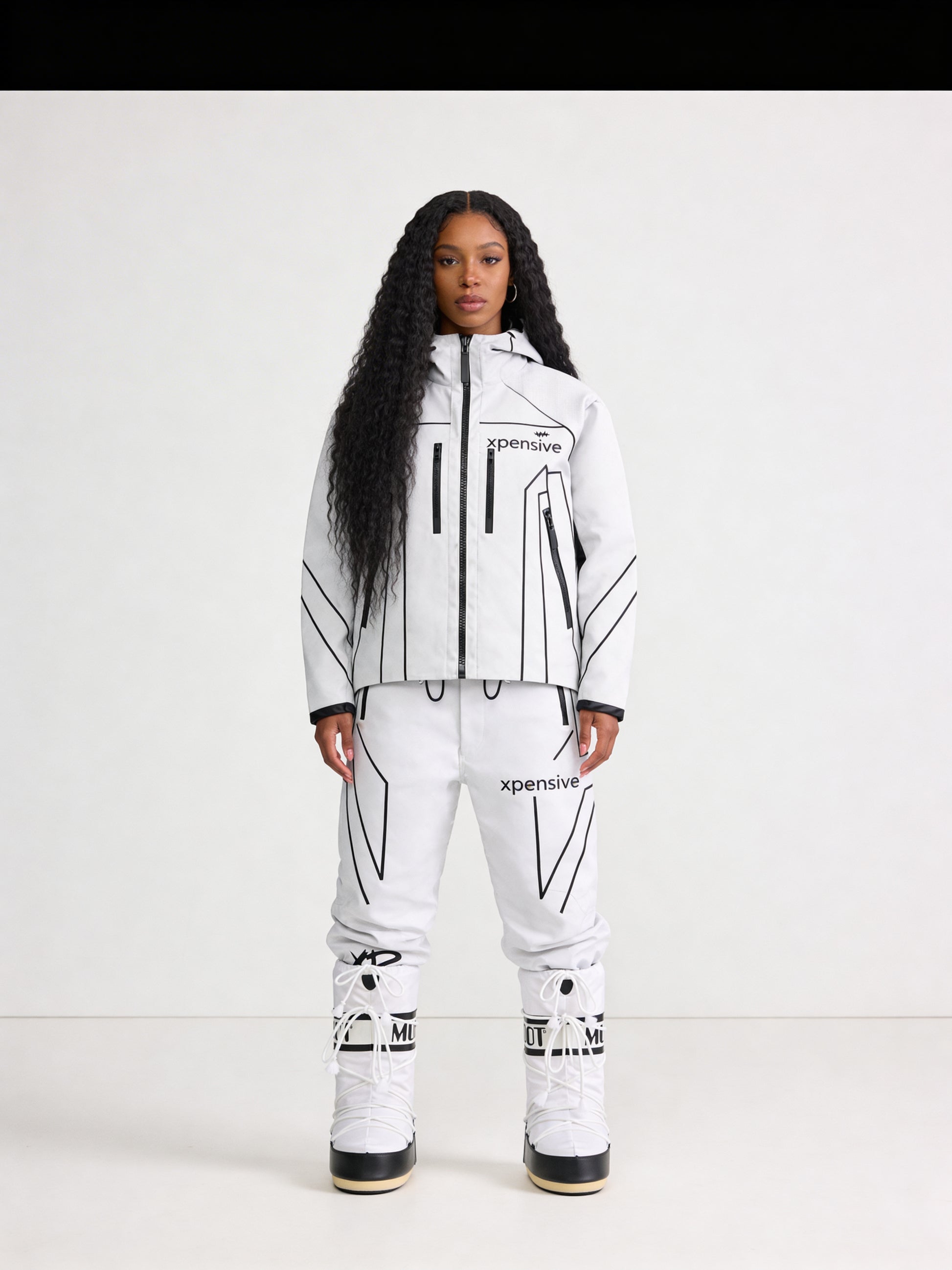 Person wearing a white and black snowsuit with 'Xpedition' branding on a white background